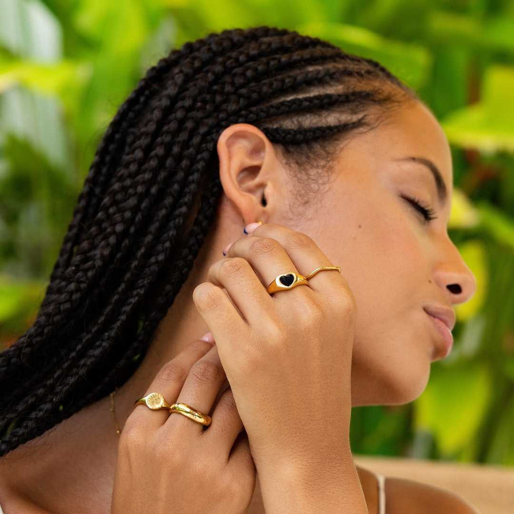 Woman wearing gold waterproof rings by Bay of Hayley