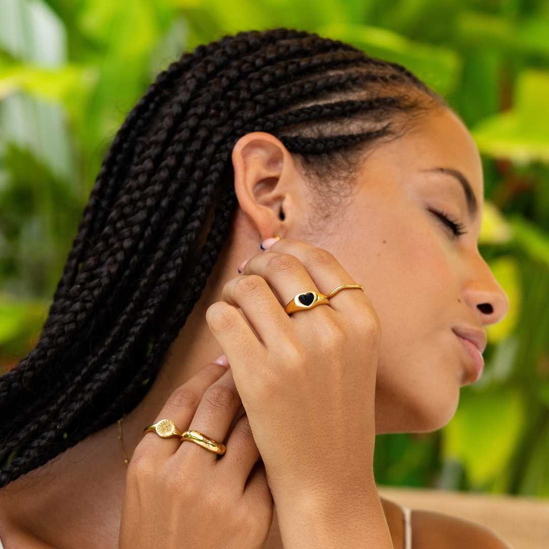Woman wearing gold waterproof rings by Bay of Hayley