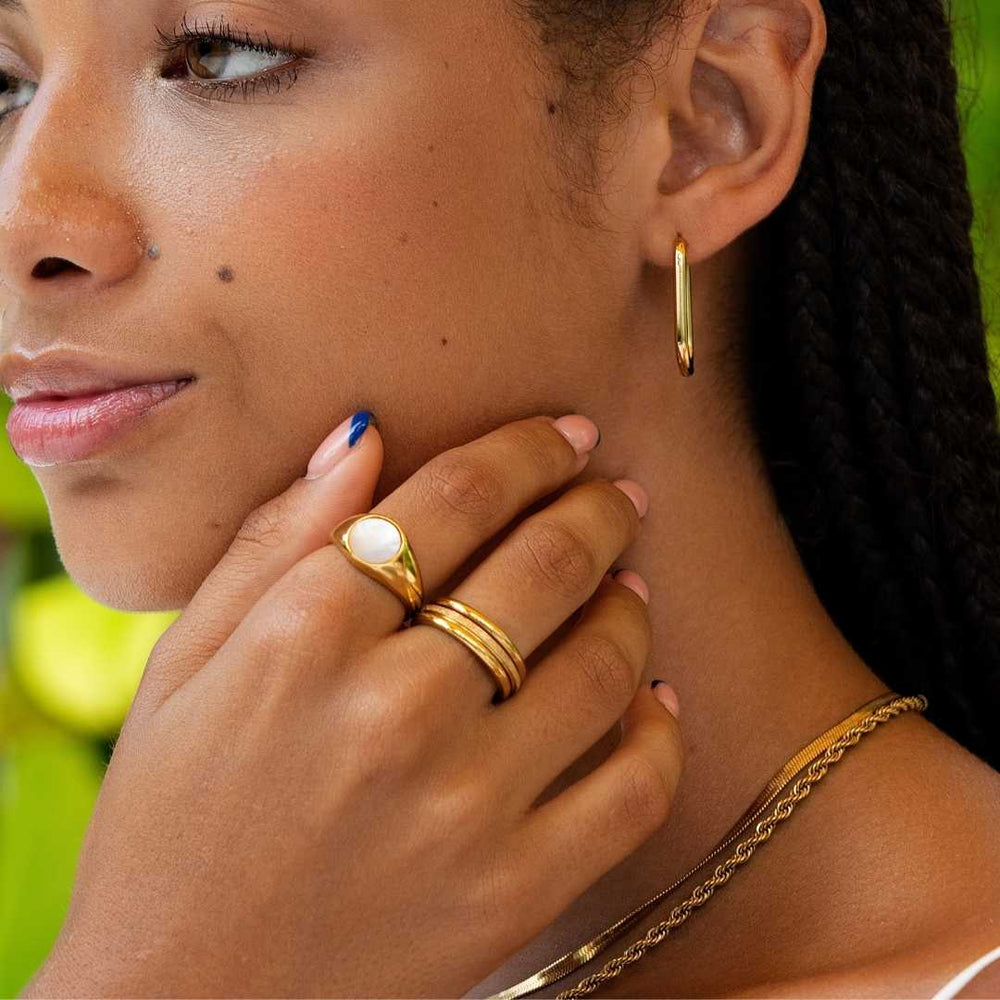Woman wearing gold waterproof rings by Bay of Hayley